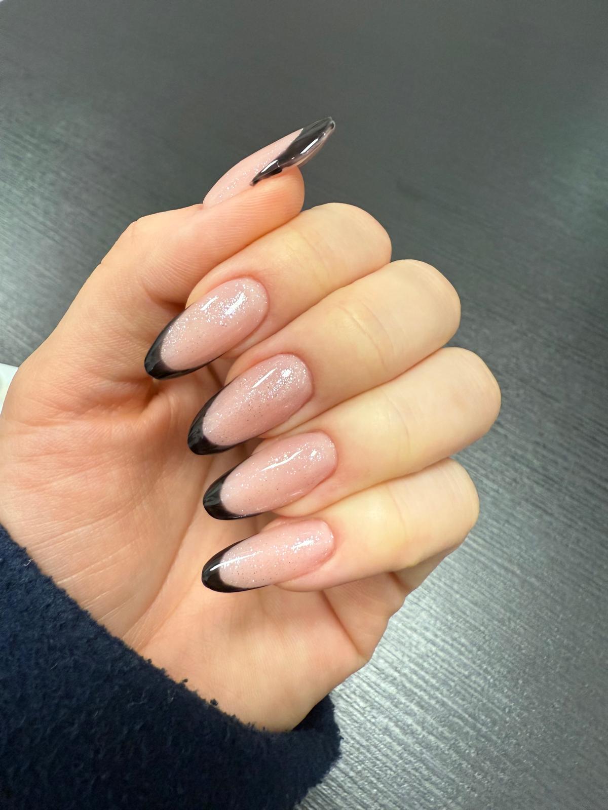 Elegancki czarny french manicure na paznokciach typu migdał